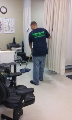 Klean All USA Inc. janitor in Woodhaven, NY mopping floor.